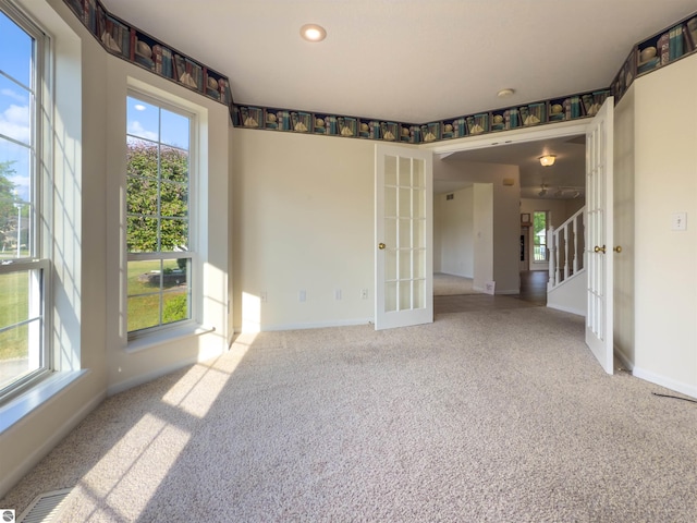 318 Red Maple Ln, Shepherd, MI 48883 - empty room with french doors, carpet flooring, recessed lighting, stairs, and a smoke detector