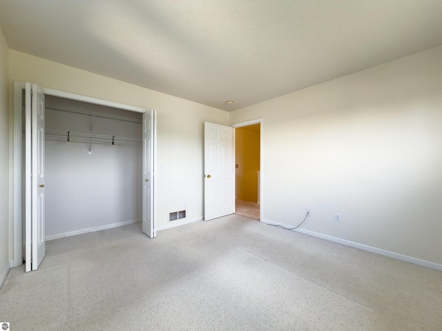 318 Red Maple Ln, Shepherd, MI 48883 - unfurnished bedroom featuring a closet and light colored carpet