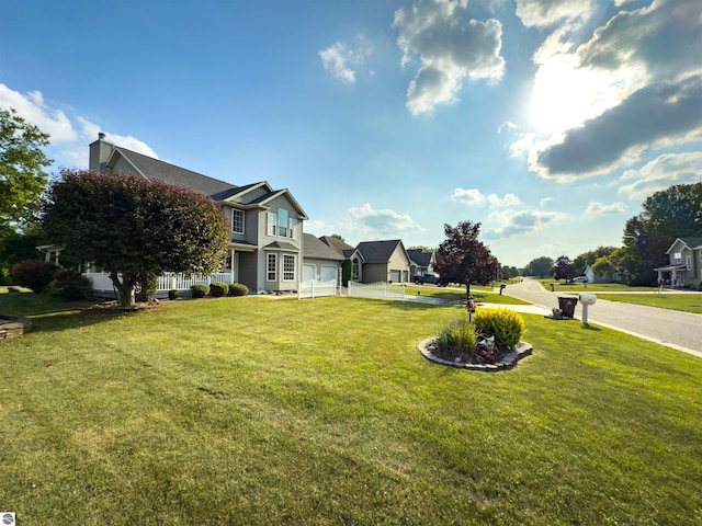 318 Red Maple Ln, Shepherd, MI 48883 - view of green lawn with concrete driveway