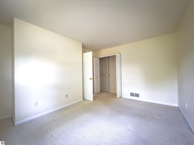 318 Red Maple Ln, Shepherd, MI 48883 - unfurnished bedroom featuring carpet floors, a closet, and a textured ceiling