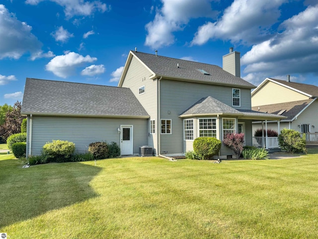 318 Red Maple Ln, Shepherd, MI 48883 - back of house with a lawn, a chimney, a porch, and a shingled roof