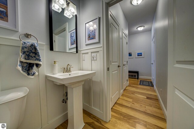 982 Lake Ridge Dr Unit 10, Traverse City, MI 49684 - half bath featuring wood finished floors and toilet