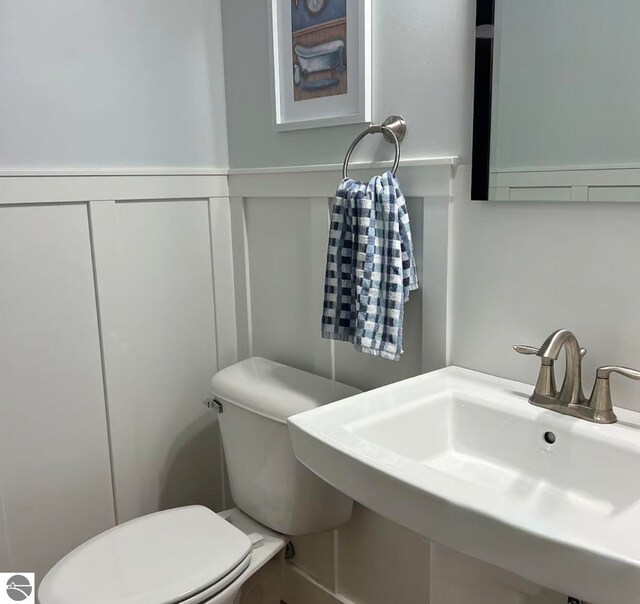 982 Lake Ridge Dr Unit 10, Traverse City, MI 49684 - half bath featuring a decorative wall and wainscoting