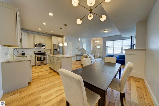 982 Lake Ridge Dr Unit 10, Traverse City, MI 49684 - dining room featuring light wood finished floors and recessed lighting