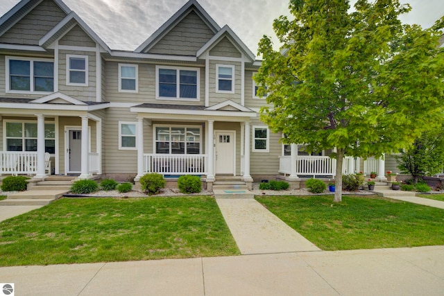 982 Lake Ridge Dr Unit 10, Traverse City, MI 49684 - view of front of house featuring covered porch and a front lawn