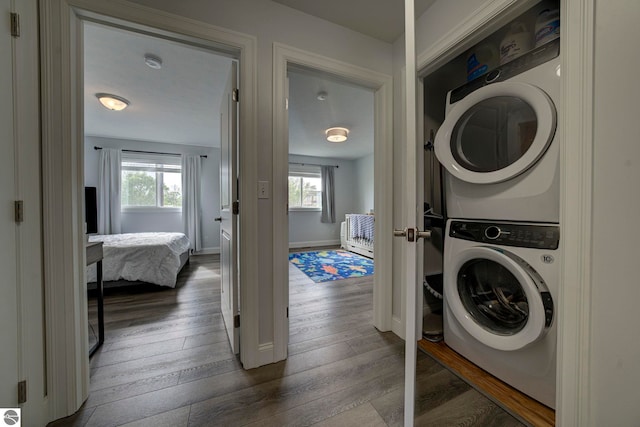 982 Lake Ridge Dr Unit 10, Traverse City, MI 49684 - laundry room featuring stacked washer and clothes dryer and wood finished floors