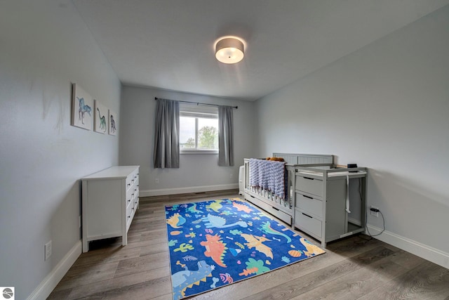 982 Lake Ridge Dr Unit 10, Traverse City, MI 49684 - bedroom with wood finished floors and baseboards