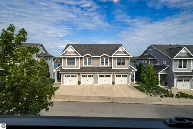 982 Lake Ridge Dr Unit 10, Traverse City, MI 49684 - view of front of property with concrete driveway, an attached garage, and a residential view