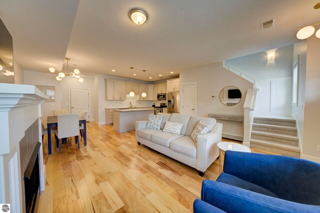 982 Lake Ridge Dr Unit 10, Traverse City, MI 49684 - living room featuring light wood-style floors, stairs, a fireplace, and recessed lighting