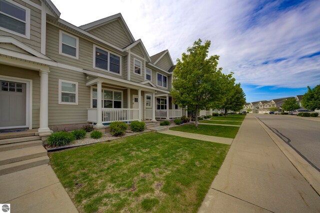 982 Lake Ridge Dr Unit 10, Traverse City, MI 49684 - view of property with covered porch and a front lawn