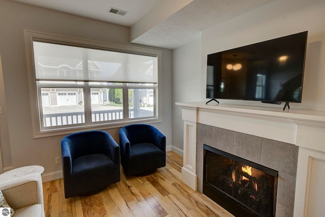 982 Lake Ridge Dr Unit 10, Traverse City, MI 49684 - living area with a fireplace and light wood-type flooring