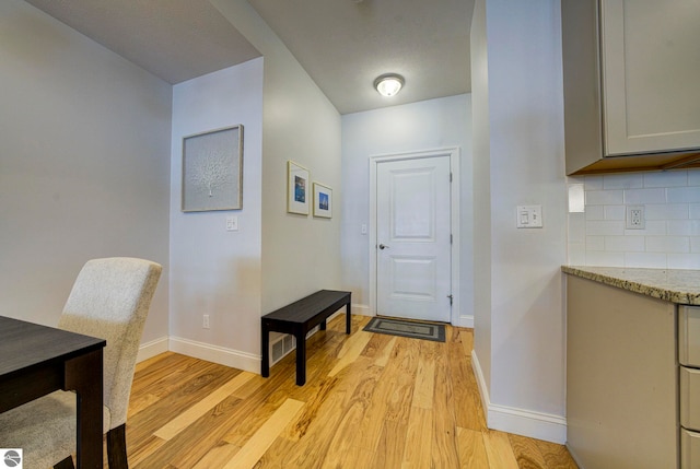 982 Lake Ridge Dr Unit 10, Traverse City, MI 49684 - foyer entrance with light wood finished floors and baseboards