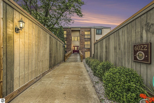 6022 Holt Rd Unit 2, Williamsburg, MI 49690 - view of exterior entry at dusk