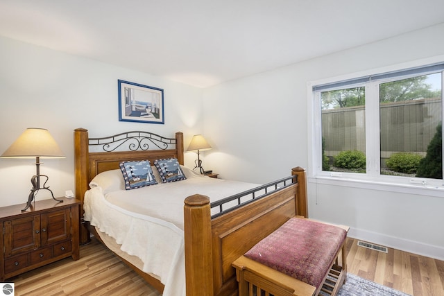 6022 Holt Rd Unit 2, Williamsburg, MI 49690 - bedroom with light wood-style floors and baseboards