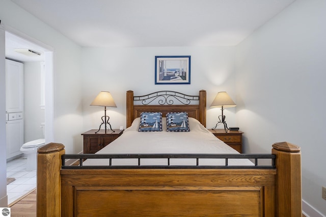 6022 Holt Rd Unit 2, Williamsburg, MI 49690 - bedroom featuring connected bathroom and baseboards