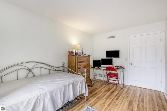 6022 Holt Rd Unit 2, Williamsburg, MI 49690 - bedroom featuring wood finished floors and an office area