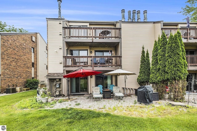 6022 Holt Rd Unit 2, Williamsburg, MI 49690 - back of house with a balcony and a lawn