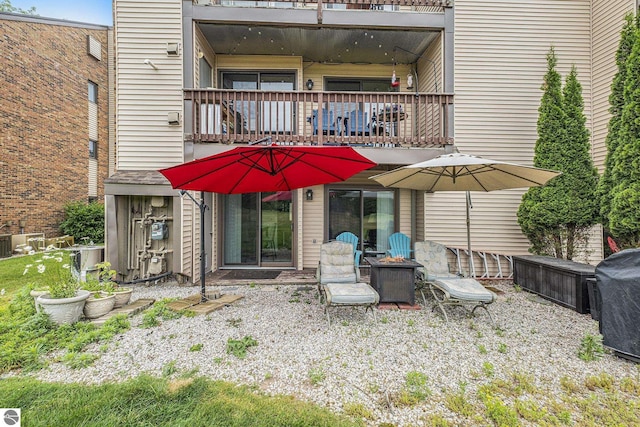 6022 Holt Rd Unit 2, Williamsburg, MI 49690 - back of house with a balcony and an outdoor fire pit