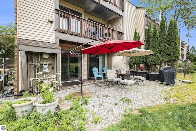 6022 Holt Rd Unit 2, Williamsburg, MI 49690 - back of property featuring a balcony and a patio