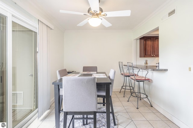 6022 Holt Rd Unit 2, Williamsburg, MI 49690 - dining room featuring ornamental molding, light tile patterned floors, and ceiling fan