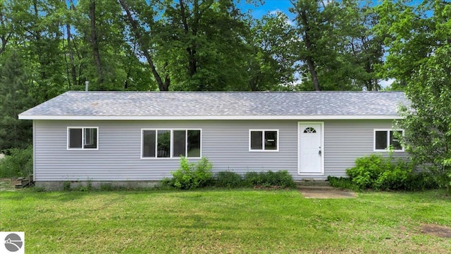 3594 Channel Rd, Hale, MI 48739 - ranch-style home featuring a front yard and roof with shingles