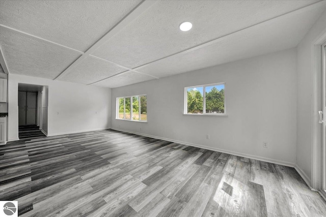 3594 Channel Rd, Hale, MI 48739 - unfurnished room with dark wood finished floors and a textured ceiling