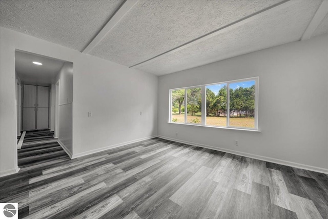 3594 Channel Rd, Hale, MI 48739 - unfurnished room with wood finished floors and a textured ceiling
