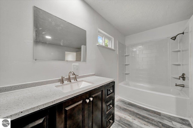 3594 Channel Rd, Hale, MI 48739 - full bathroom featuring wood finished floors, a textured ceiling, vanity, and shower / bathtub combination