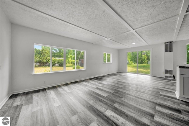 3594 Channel Rd, Hale, MI 48739 - unfurnished living room with a heating unit and wood finished floors