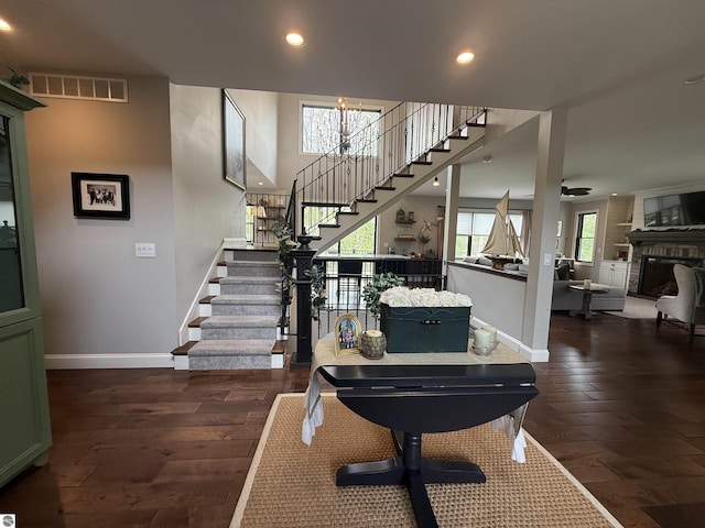 777 Stoneridge Dr, Mount Pleasant, MI 48858 - staircase featuring hardwood / wood-style floors, recessed lighting, a large fireplace, and ceiling fan