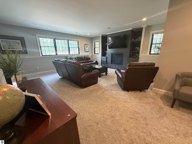 777 Stoneridge Dr, Mount Pleasant, MI 48858 - carpeted living area featuring a glass covered fireplace, plenty of natural light, and recessed lighting