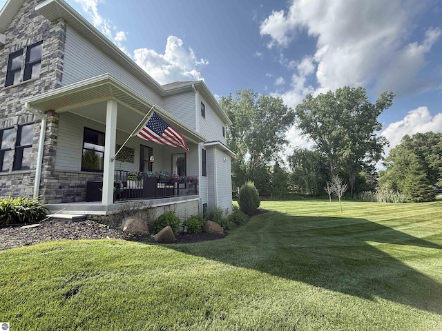 777 Stoneridge Dr, Mount Pleasant, MI 48858 - view of side of property with a yard, stone siding, and covered porch