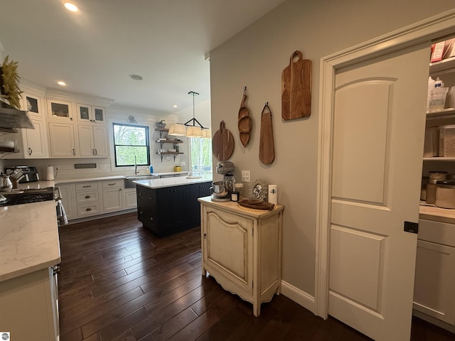 777 Stoneridge Dr, Mount Pleasant, MI 48858 - kitchen with white cabinets, dark wood-style floors, glass insert cabinets, recessed lighting, and light stone counters