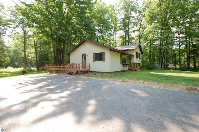 1294 Stoney Ridge Rd, West Branch, MI 48661 - view of side of property with a deck and a lawn