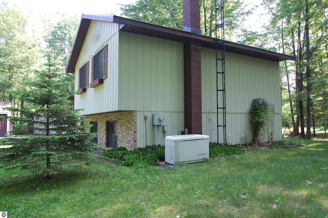 1294 Stoney Ridge Rd, West Branch, MI 48661 - view of side of home featuring a chimney, a lawn, and brick siding