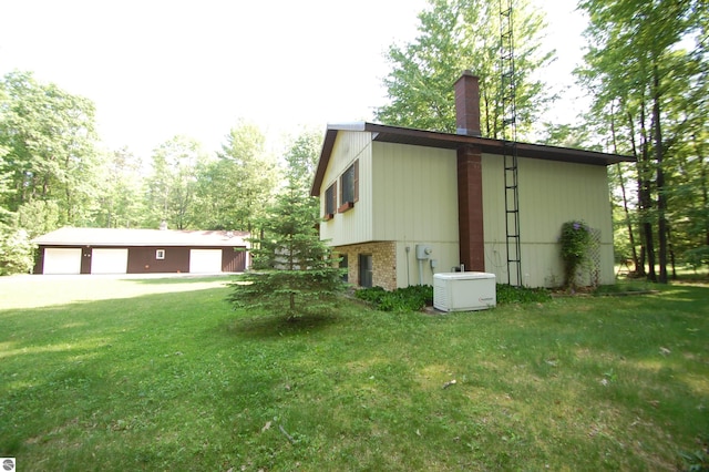1294 Stoney Ridge Rd, West Branch, MI 48661 - view of side of property with a garage, a chimney, a lawn, an outbuilding, and brick siding