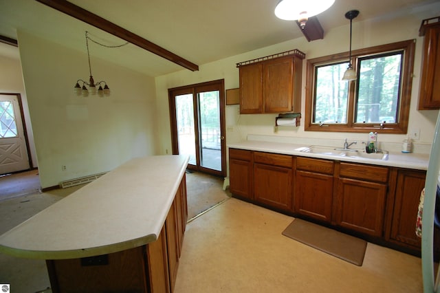 1294 Stoney Ridge Rd, West Branch, MI 48661 - kitchen featuring brown cabinets, decorative light fixtures, and light countertops