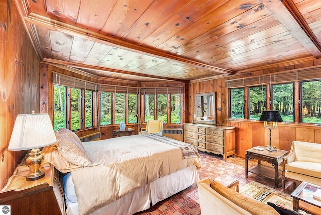 7822 W Welch Rd, Empire, MI 49630 - bedroom with wood ceiling, wood walls, multiple windows, and brick patterned floors