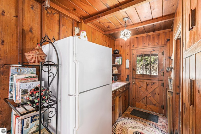 7822 W Welch Rd, Empire, MI 49630 - kitchen with freestanding refrigerator, a wooden ceiling with exposed beams, wood walls, open shelves, and brown cabinetry