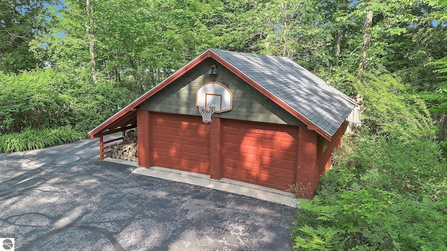 7822 W Welch Rd, Empire, MI 49630 - garage with a garage and a view of trees