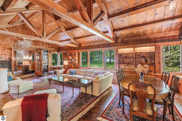 7822 W Welch Rd, Empire, MI 49630 - living area featuring wooden ceiling, wooden walls, healthy amount of natural light, and wood-type flooring