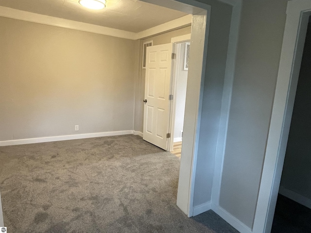 702 N Grafton Ave, Alma, MI 48801 - spare room with dark carpet