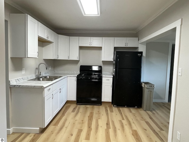 702 N Grafton Ave, Alma, MI 48801 - kitchen featuring black appliances, light wood-type flooring, white cabinets, and crown molding