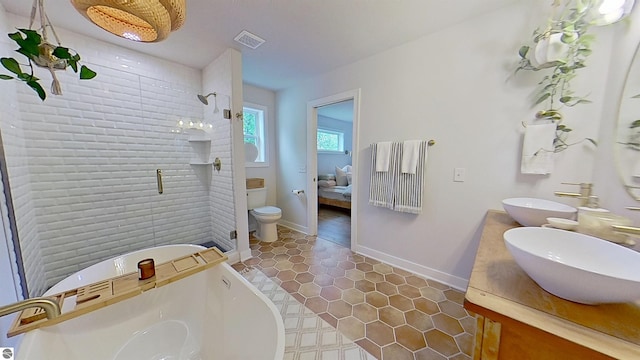 84 9 Mile Rd NW, Comstock Park, MI 49321 - full bathroom with double vanity, a stall shower, a freestanding bath, tile patterned floors, and ensuite bath