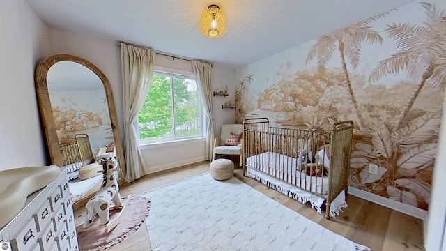 84 9 Mile Rd NW, Comstock Park, MI 49321 - bedroom with light wood-style floors and a nursery area