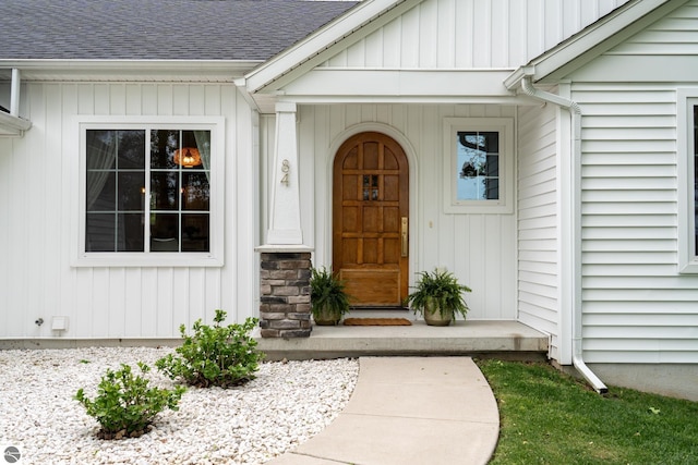 84 9 Mile Rd NW, Comstock Park, MI 49321 - doorway to property with a shingled roof and board and batten siding