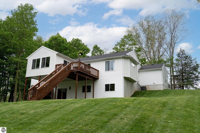 84 9 Mile Rd NW, Comstock Park, MI 49321 - back of house featuring stairs, a wooden deck, and a lawn
