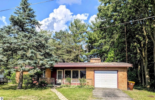 1519 Ridge Rdg, Mount Pleasant, MI 48858 - view of front of property featuring a porch, brick siding, a garage, a front yard, and driveway
