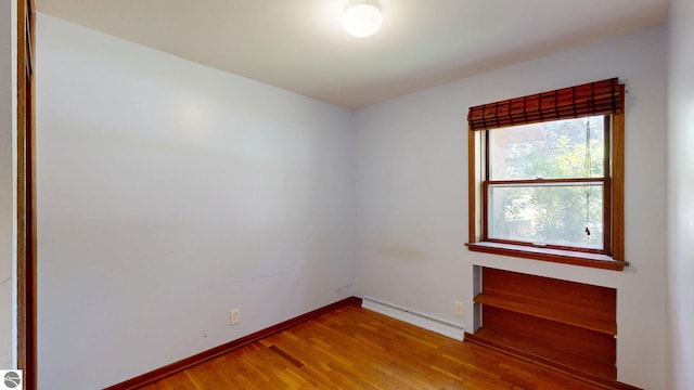 1519 Ridge Rdg, Mount Pleasant, MI 48858 - spare room with baseboard heating and wood finished floors