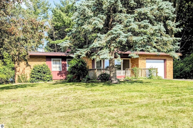 1519 Ridge Rdg, Mount Pleasant, MI 48858 - view of front facade with brick siding, a front yard, covered porch, and an attached garage